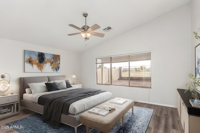 bedroom with vaulted ceiling, ceiling fan, and dark wood-type flooring