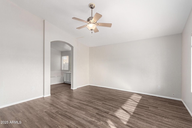 empty room with ceiling fan and dark wood-type flooring