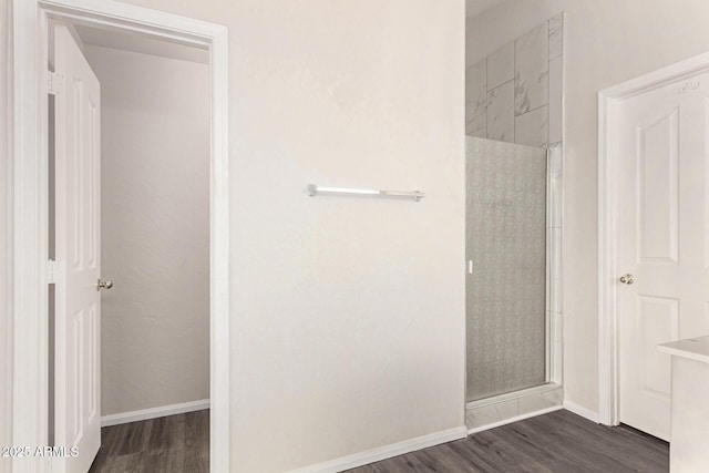 bathroom featuring wood-type flooring and a shower with door