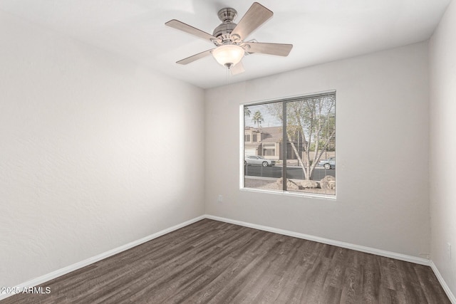 empty room with dark hardwood / wood-style floors and ceiling fan