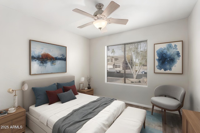 bedroom with ceiling fan and hardwood / wood-style flooring