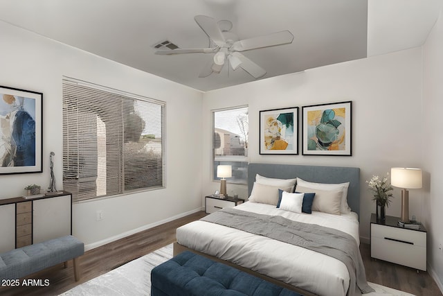 bedroom with dark hardwood / wood-style flooring and ceiling fan