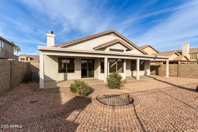 rear view of house featuring central AC and a patio area