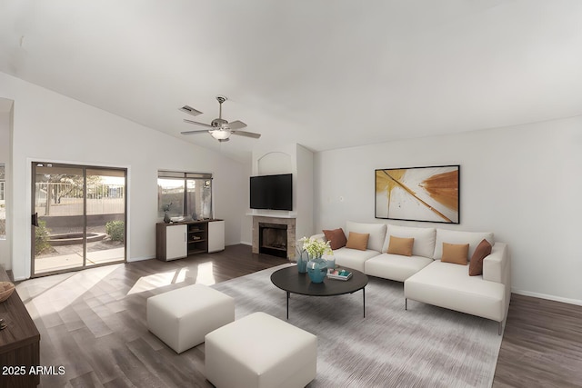 living room with hardwood / wood-style flooring, vaulted ceiling, and ceiling fan