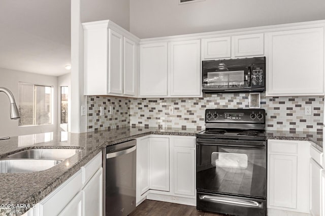 kitchen with sink, white cabinetry, dark stone counters, and black appliances