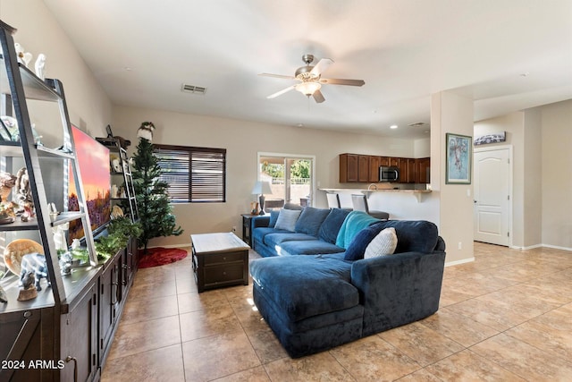 living room with ceiling fan and light tile patterned flooring