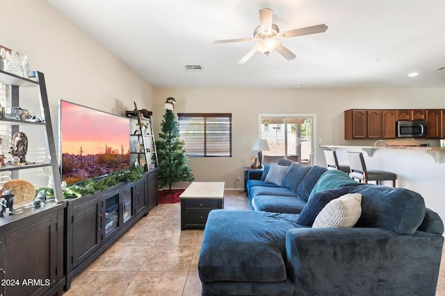 living room featuring ceiling fan and light tile patterned floors