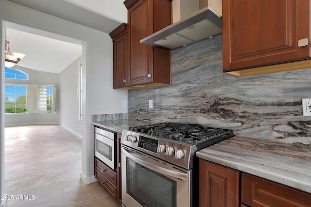 kitchen featuring stainless steel appliances, an inviting chandelier, backsplash, wall chimney range hood, and light countertops