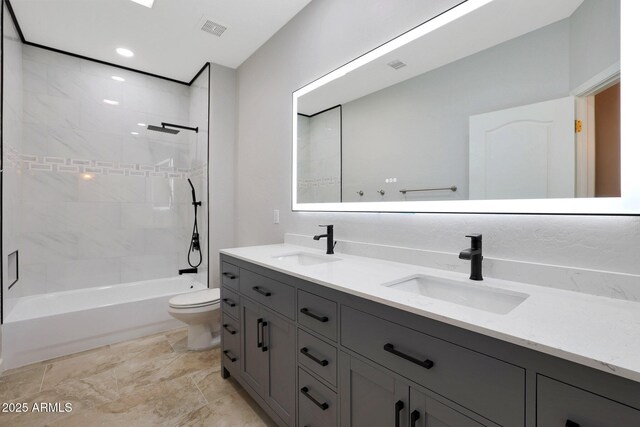 full bath with toilet, a sink, visible vents, and double vanity