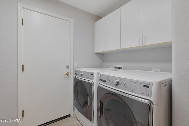 laundry area featuring independent washer and dryer and cabinet space