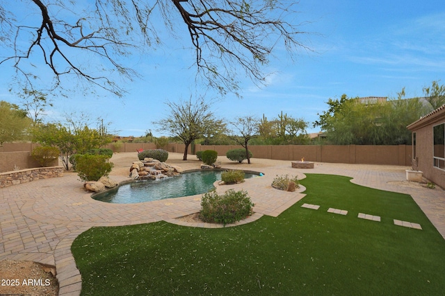 view of swimming pool with a lawn, a patio area, a fenced backyard, and a fenced in pool