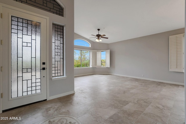 foyer entrance featuring lofted ceiling, baseboards, and ceiling fan