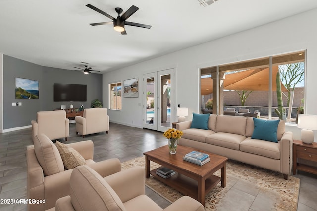 living area featuring baseboards and ceiling fan