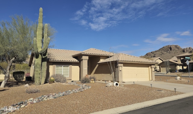 view of front of house with a garage and a mountain view