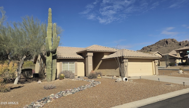 view of front of home with a garage and a mountain view