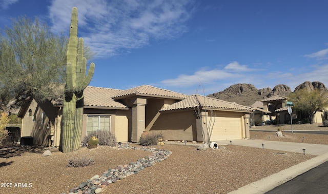 view of front of property featuring a garage and a mountain view