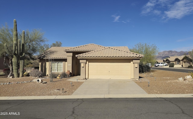 view of front facade featuring a mountain view and a garage