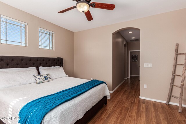 bedroom with ceiling fan and dark hardwood / wood-style floors