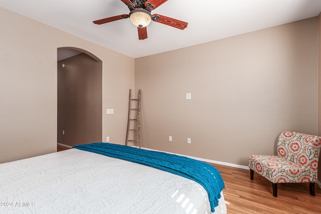 bedroom with hardwood / wood-style floors and ceiling fan