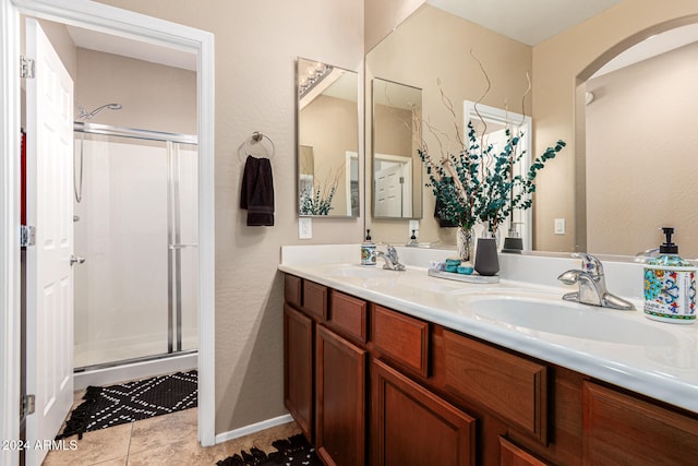 bathroom with vanity, a shower with shower door, and tile patterned flooring