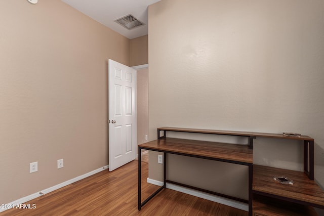 home office with hardwood / wood-style flooring