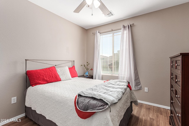 bedroom featuring dark hardwood / wood-style floors and ceiling fan