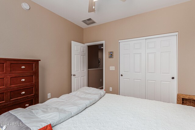 bedroom featuring ceiling fan and a closet