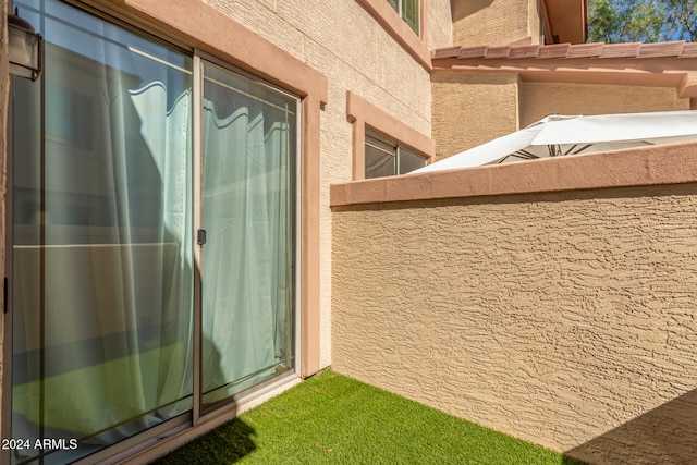 view of exterior entry featuring a balcony