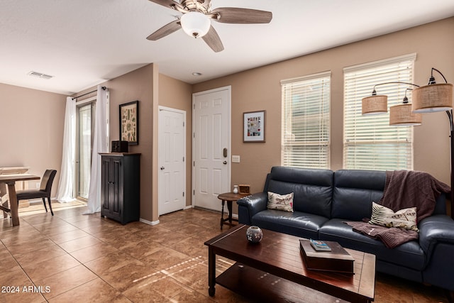 tiled living room with ceiling fan