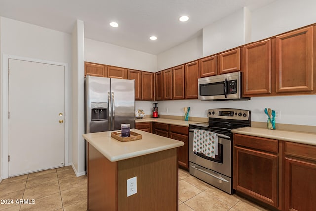 kitchen featuring a kitchen island, appliances with stainless steel finishes, and light tile patterned floors