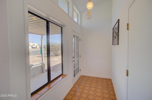 entryway featuring baseboards and tile patterned floors