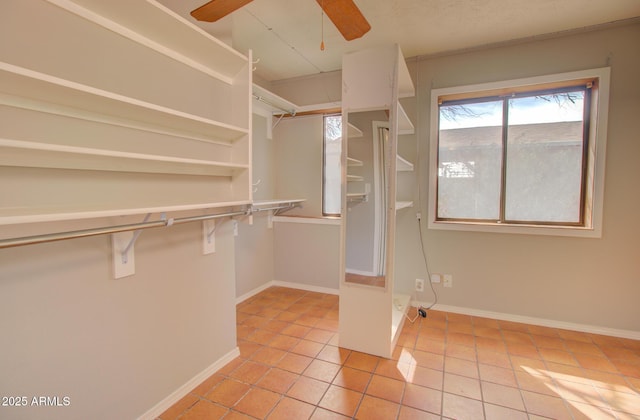 spacious closet featuring ceiling fan and light tile patterned floors