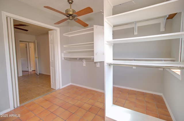 spacious closet with ceiling fan and tile patterned flooring