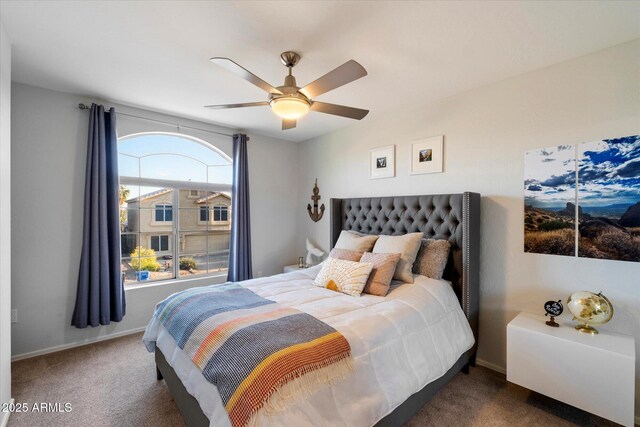carpeted bedroom with a ceiling fan and baseboards