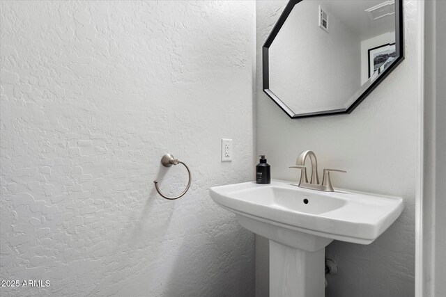 bathroom with a textured wall