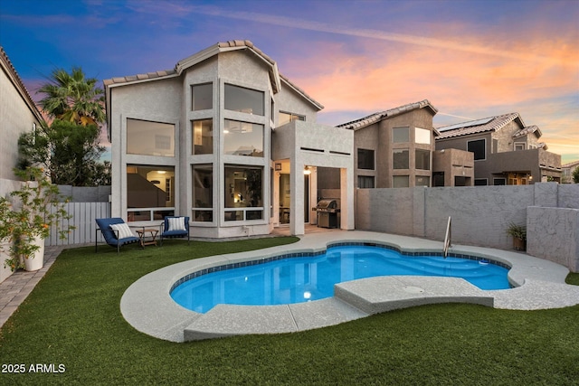 rear view of property with a balcony, stucco siding, and a patio