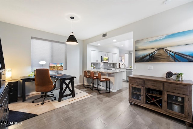 dining room with an office area and recessed lighting