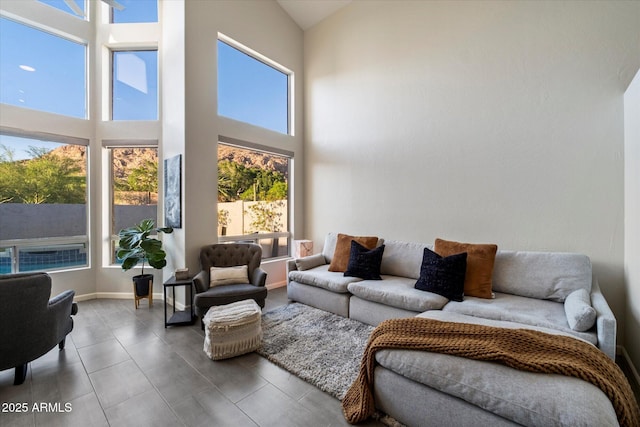 living room featuring a towering ceiling
