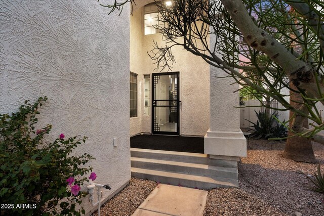 entrance to property with stucco siding
