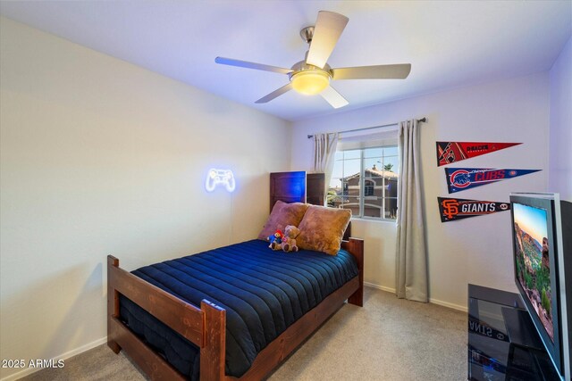 carpeted bedroom with baseboards and a ceiling fan