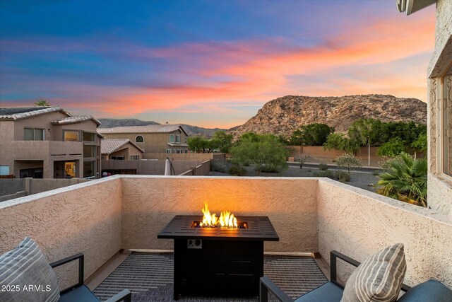 balcony with an outdoor fire pit and a mountain view