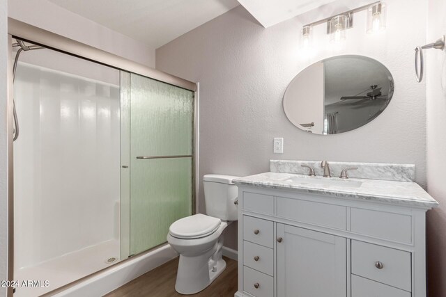 455 S Delaware Dr Unit 120, Apache Junction, AZ 85120 - bathroom with wood finished floors, a stall shower, toilet, vanity, and a ceiling fan