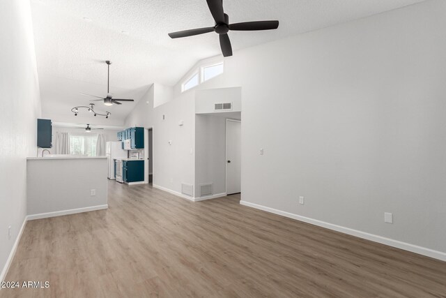 455 S Delaware Dr Unit 120, Apache Junction, AZ 85120 - unfurnished living room with a ceiling fan, wood finished floors, plenty of natural light, a textured ceiling, and high vaulted ceiling