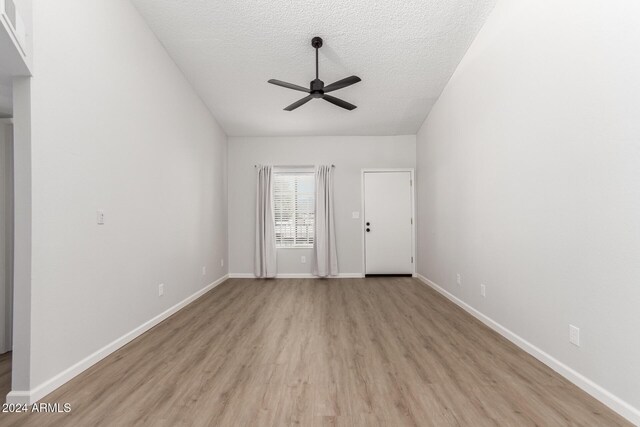 455 S Delaware Dr Unit 120, Apache Junction, AZ 85120 - unfurnished living room with a ceiling fan, light wood finished floors, a textured ceiling, and baseboards