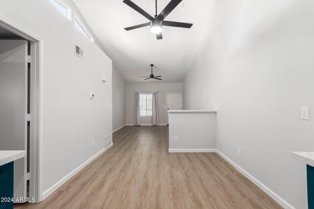 455 S Delaware Dr Unit 120, Apache Junction, AZ 85120 - empty room featuring ceiling fan, light wood-style flooring, vaulted ceiling, baseboards, and a textured ceiling