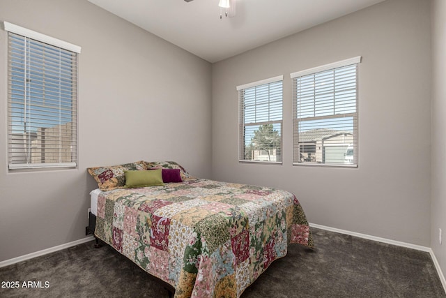 bedroom featuring dark colored carpet and ceiling fan