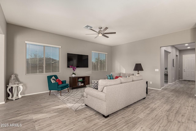 living room with ceiling fan and light wood-type flooring