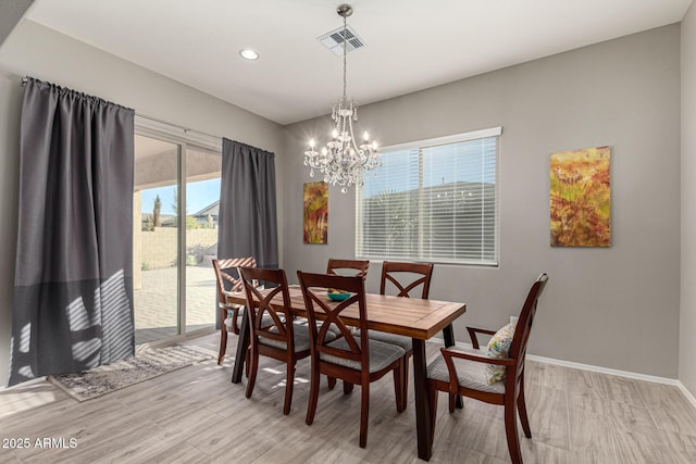 dining area featuring a chandelier and light wood-type flooring