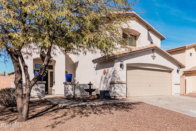 view of front of home with a garage, driveway, a tile roof, and stucco siding