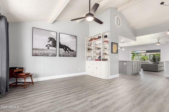 living area featuring a ceiling fan, light wood-style flooring, and baseboards